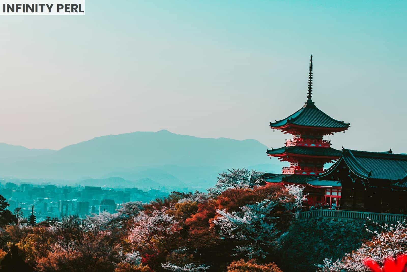 Scenic view of Kiyomizu-dera Temple with cherry blossoms in Kyoto, Japan, capturing traditional Japanese architecture at twilight.