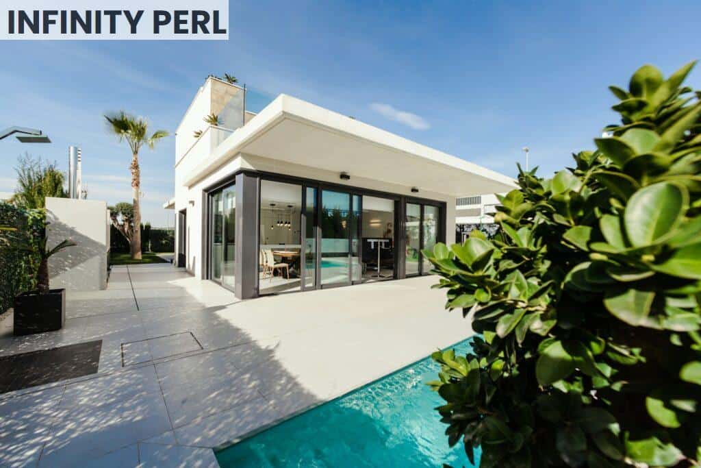 white and grey concrete building near swimming pool under clear sky during daytime