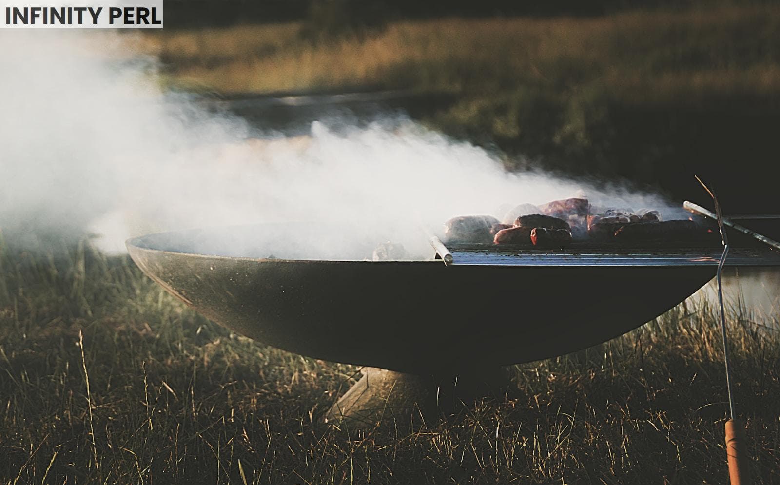lighted black metal grill with meat on top